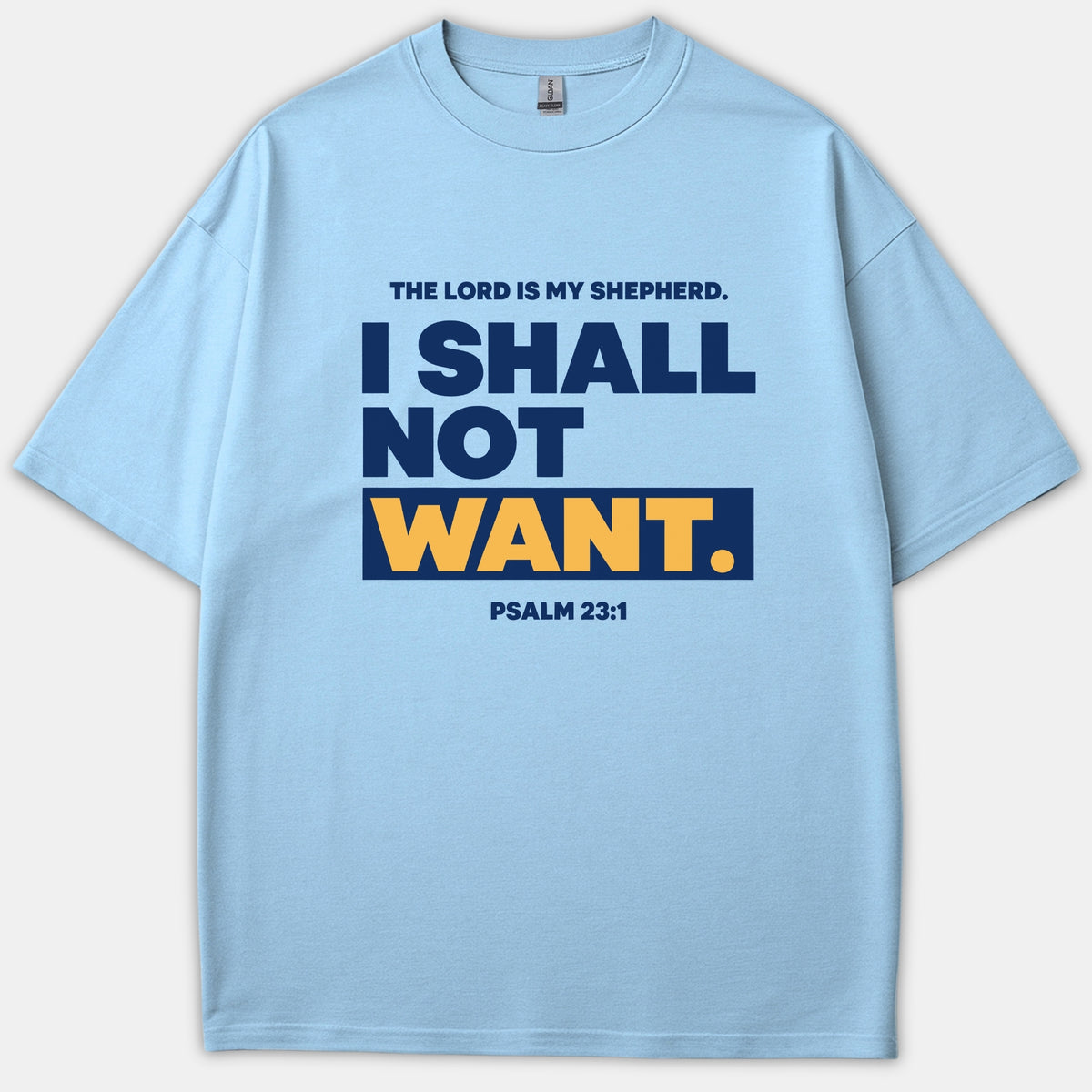 A light blue Christian t-shirt featuring the Scripture quote 'The Lord is my shepherd, I shall not want' from Psalm 23:1 printed in bold navy and yellow typography.