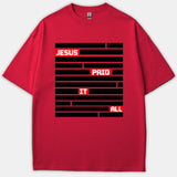 A red Christian T-shirt featuring a black redacted-style block design with the words JESUS PAID IT ALL highlighted in bold white lettering inside red boxes.