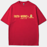 A red Christian T-shirt displaying a graphic text equation that reads 'FAITH - WORKS = R.I.P. FAITH (JAMES 2:26)' with a tombstone icon printed in yellow and blue.