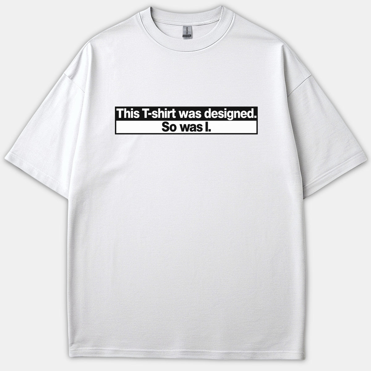 A white Christian t-shirt featuring a bold black and white graphic that reads, 'This T-shirt was designed. So was I.'