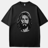 A black t-shirt featuring a graphic print of Jesus Christ's face stylized out of white fingerprint lines.