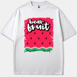 A white T-shirt featuring a vibrant watermelon graphic pattern with the words 'bear fruit' written in bold white typography.