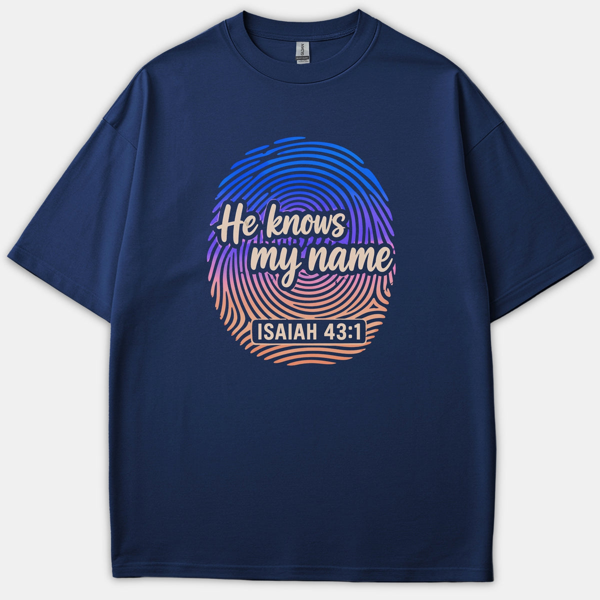 A navy blue Christian t-shirt featuring a colorful gradient fingerprint graphic with the phrase 'He knows my name' and scripture reference 'ISAIAH 43:1' in cream script.