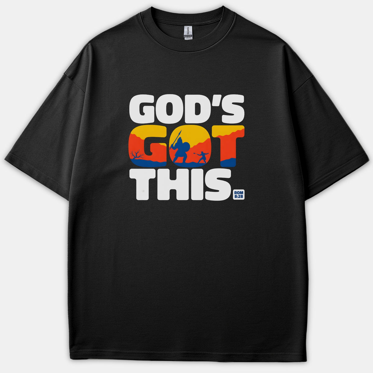 A black graphic T-shirt featuring the text GOD'S GOT THIS with a colorful David and Goliath silhouette scene inside the middle word and ROM 8:28 underneath.