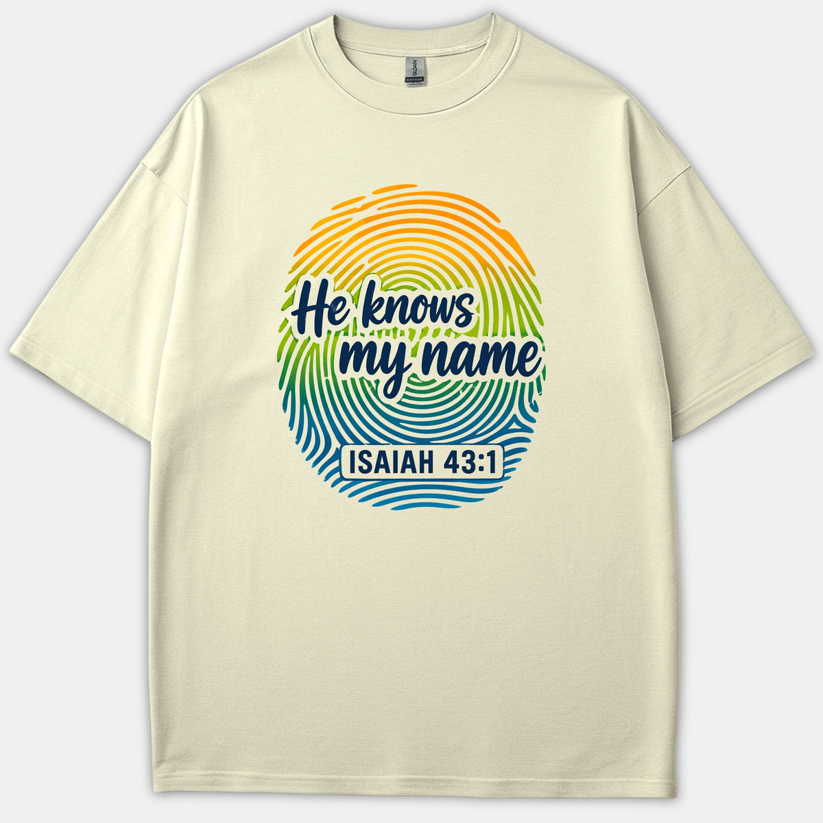 A beige Christian t-shirt featuring a colorful fingerprint design with the phrase He knows my name and scripture reference Isaiah 43:1.