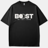 A black Christian t-shirt featuring the text BOAST IN THE LORD in bold white typography, with an empty tomb graphic cleverly incorporated into the lettering.