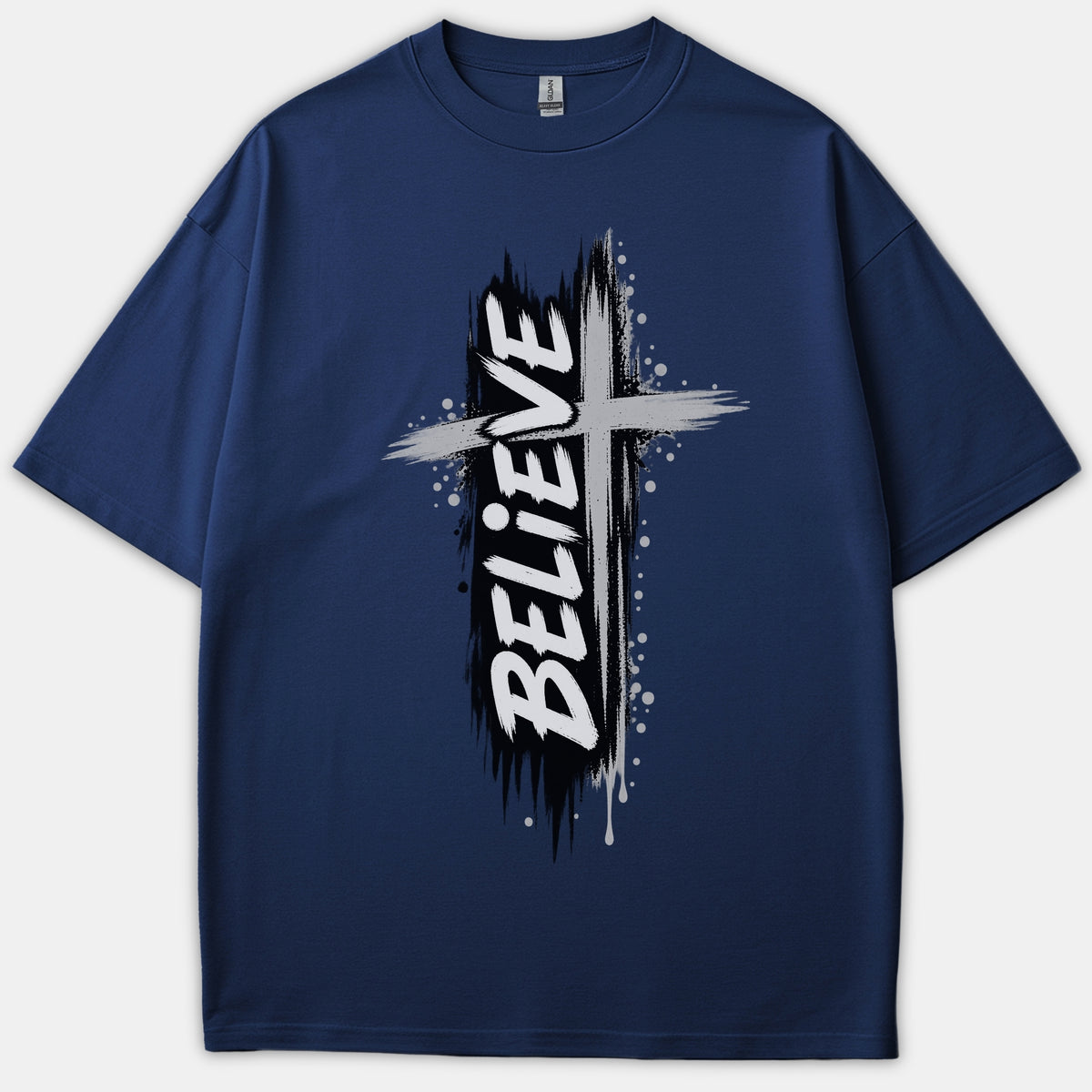 A navy blue Christian t-shirt featuring a distressed brushstroke cross graphic with the word BELIEVE printed vertically in bold white lettering.