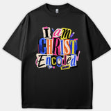 A black Christian t-shirt featuring a colorful ransom-note collage design with tech icons that reads 'I am CHRIST Encoded'.