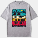 A heather gray Christian t-shirt featuring a colorful retro landscape graphic with mountains, trees, and the text JESUS. THE WAY. THE TRUTH. THE LIFE.