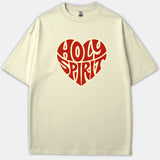 A beige Christian t-shirt featuring a red heart-shaped graphic with the words Holy Spirit written in bold, retro typography.