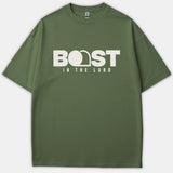 A green Christian t-shirt featuring a bold white graphic that reads BOAST IN THE LORD with an open tomb design integrated into the typography.