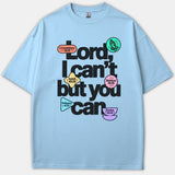 A light blue Christian T-shirt featuring bold text reading 'Lord, I can't but you can' accented by colorful shapes with Bible verse references.