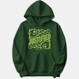 A dark green hoodie featuring the word JUSTIFIED surrounded by ornate vine illustrations and the scripture reference Galatians 2:16 printed on the front.