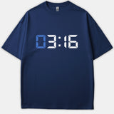 A navy blue t-shirt featuring a digital clock display graphic reading 03:16 with a light blue zero and white digits.
