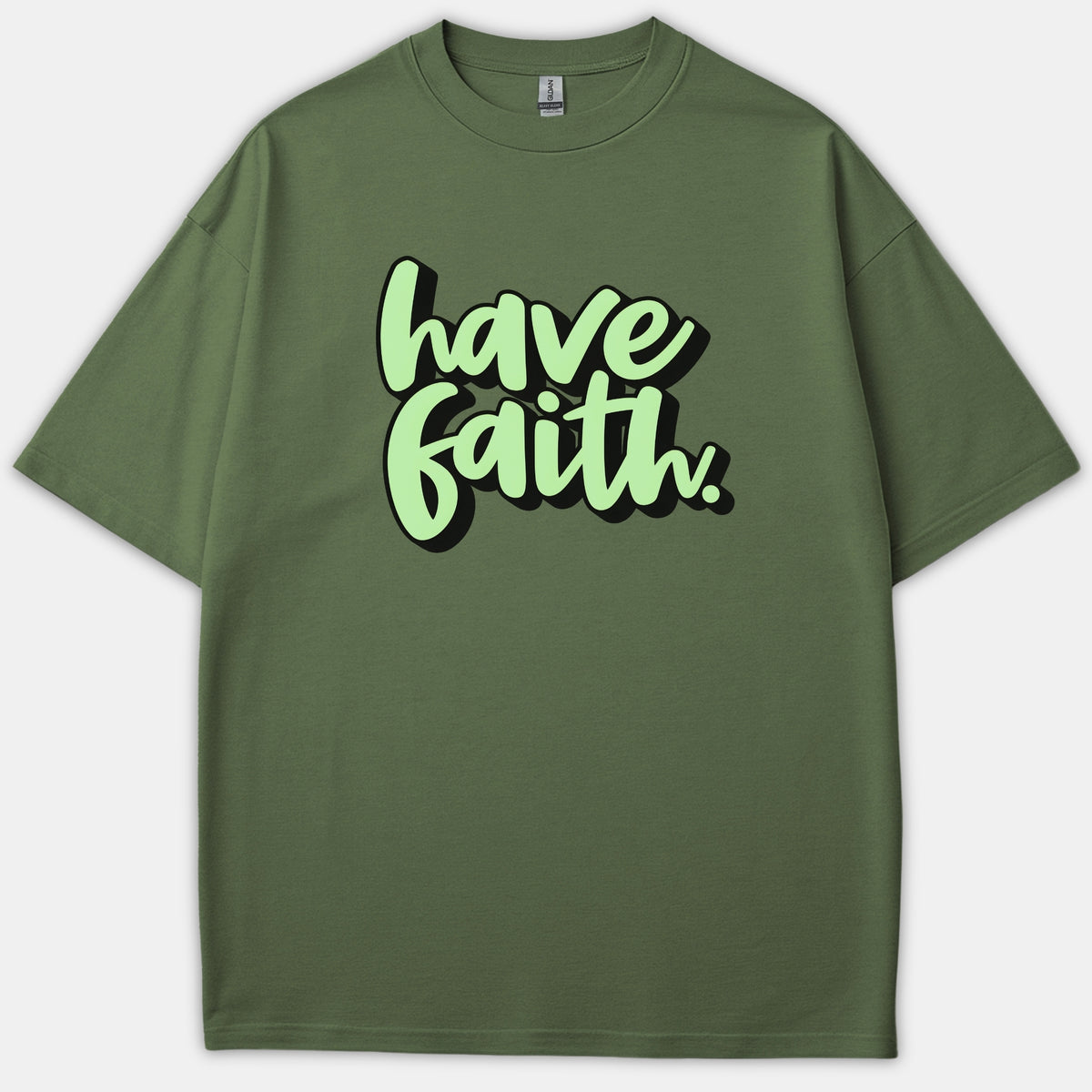 An olive green Christian t-shirt featuring the phrase Have Faith in a light green bubbly script font with a black drop shadow.