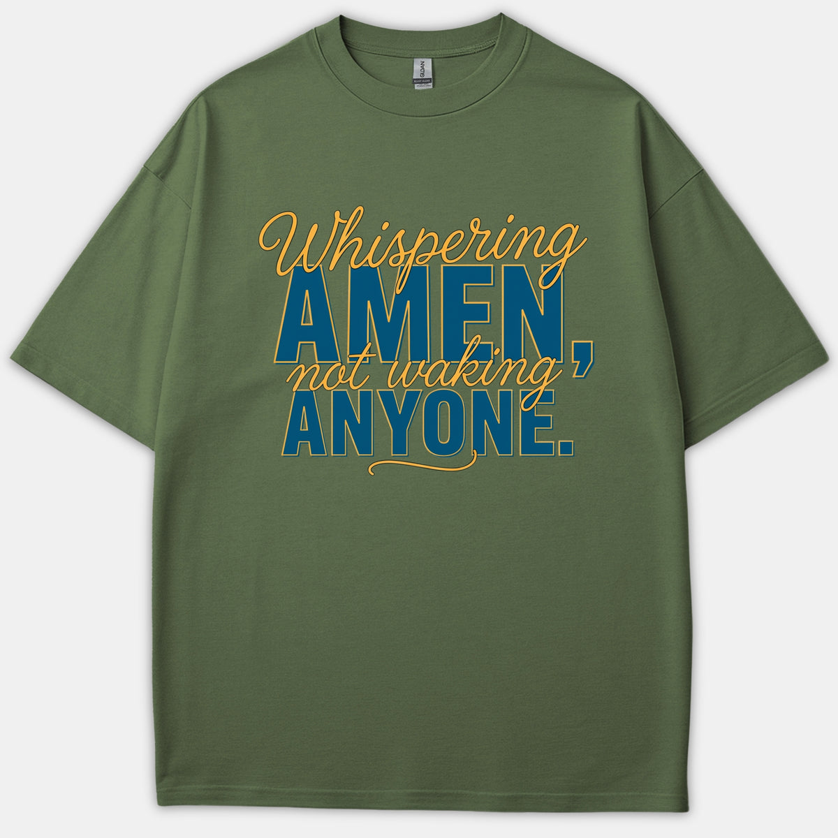 A green Christian t-shirt featuring the phrase 'Whispering AMEN, not waking ANYONE.' printed in blue and yellow typography.