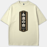A beige t-shirt featuring a black vertical banner graphic with Japanese characters, gold ornamental borders, and text reading Eternal Life John 3:16.