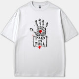 A white Christian T-shirt featuring a distressed black handprint with a red mark on the palm above the words PAID IN FULL and a small red cross.