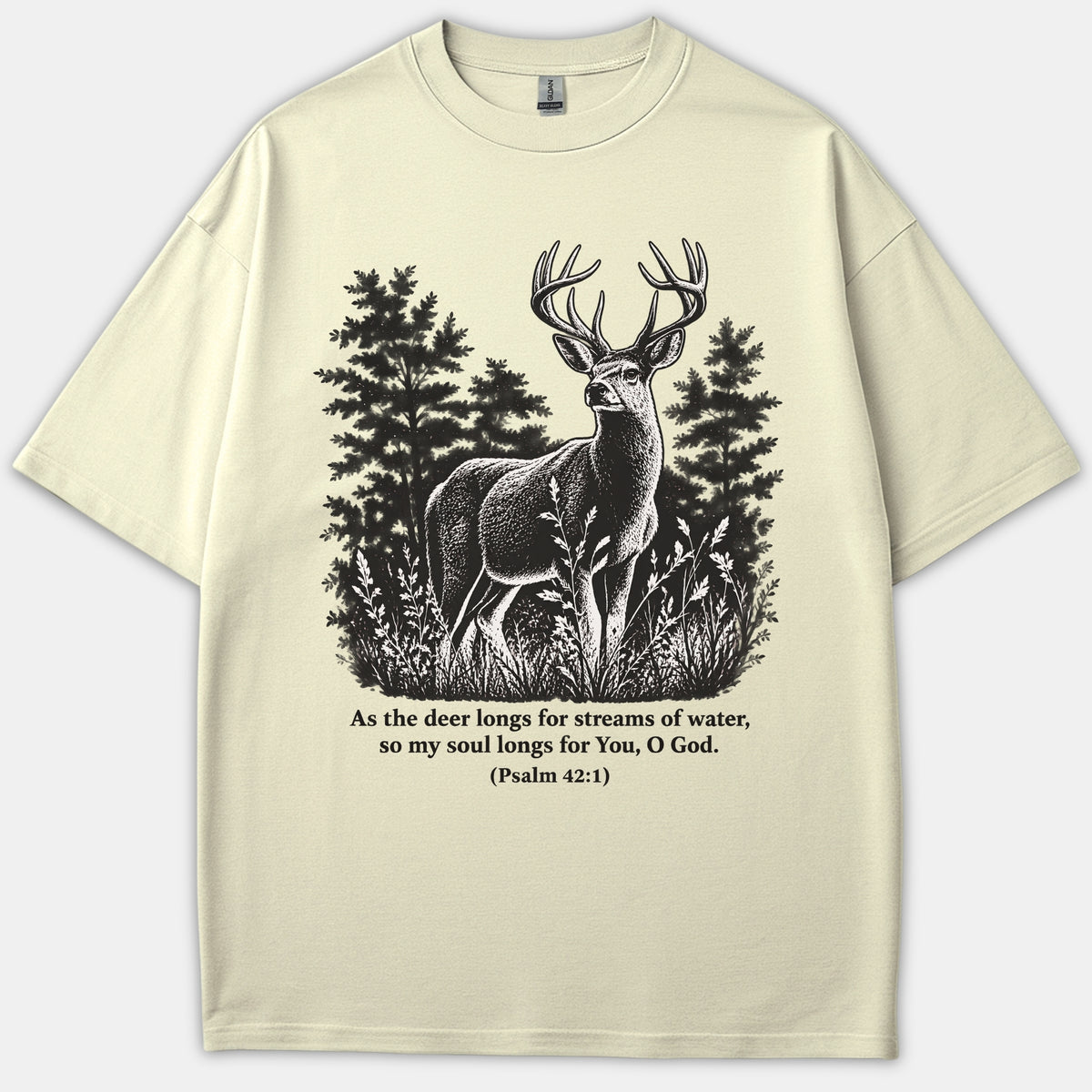 A beige T-shirt featuring a detailed black line illustration of a deer in a forest with the Bible verse Psalm 42:1 printed underneath.