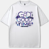 A white Christian t-shirt featuring a cosmic purple and blue galaxy graphic that reads God Is Good All The Time with Psalm 100:5.