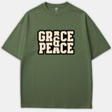 An olive green Christian t-shirt featuring the phrase Grace & Peace printed in a bold beige collegiate font with a black outline across the chest.
