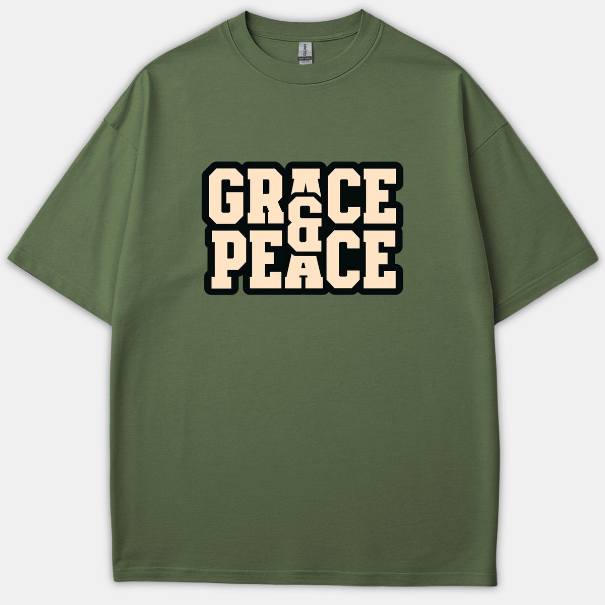 An olive green Christian t-shirt featuring the phrase Grace & Peace printed in a bold beige collegiate font with a black outline across the chest.