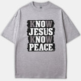 A heather gray Christian t-shirt featuring a distressed black graphic banner with the text KNOW JESUS KNOW PEACE printed in bold white and gray lettering.