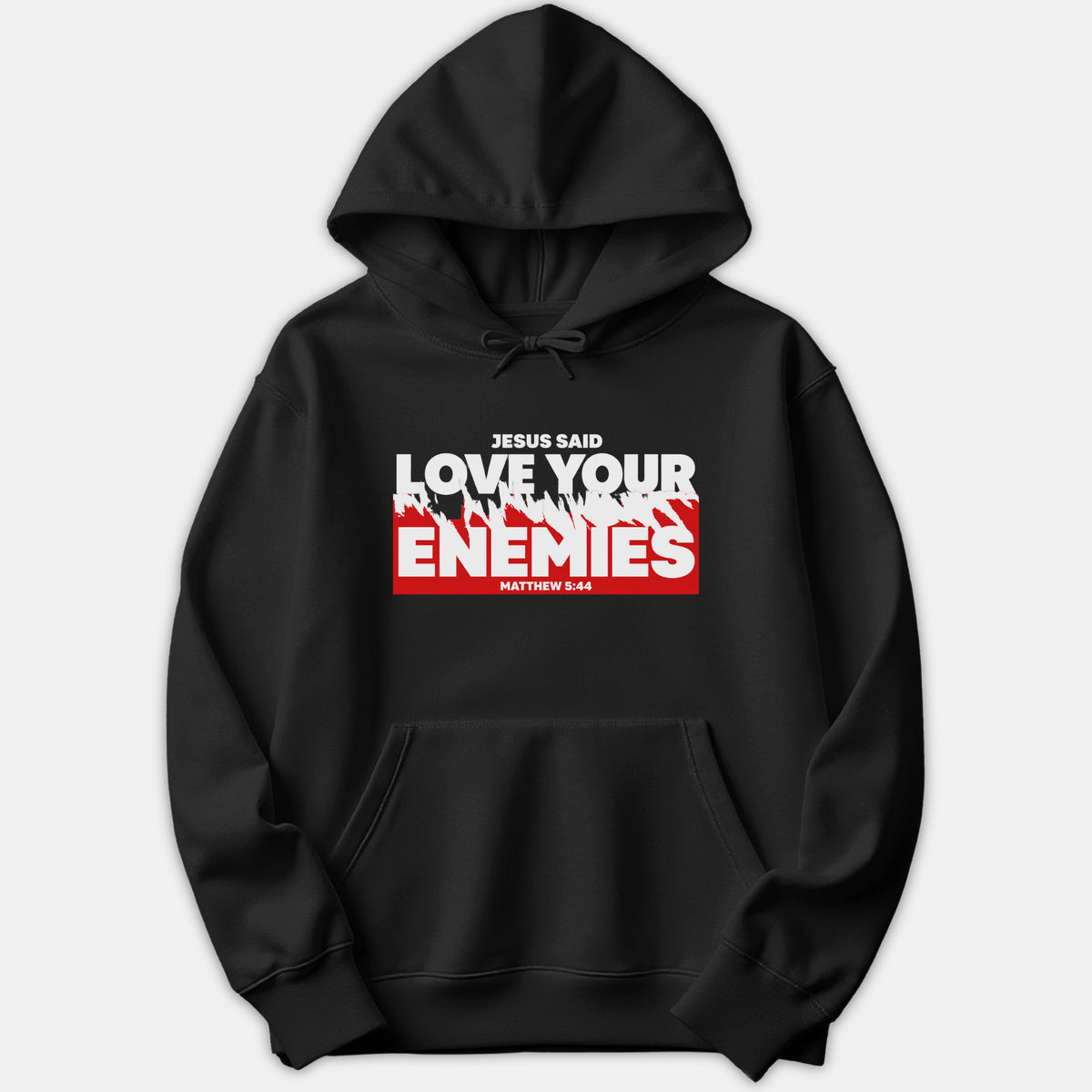 A black pullover hoodie featuring a bold Christian graphic print that reads 'Jesus Said Love Your Enemies' with scripture reference Matthew 5:44 in red and white.