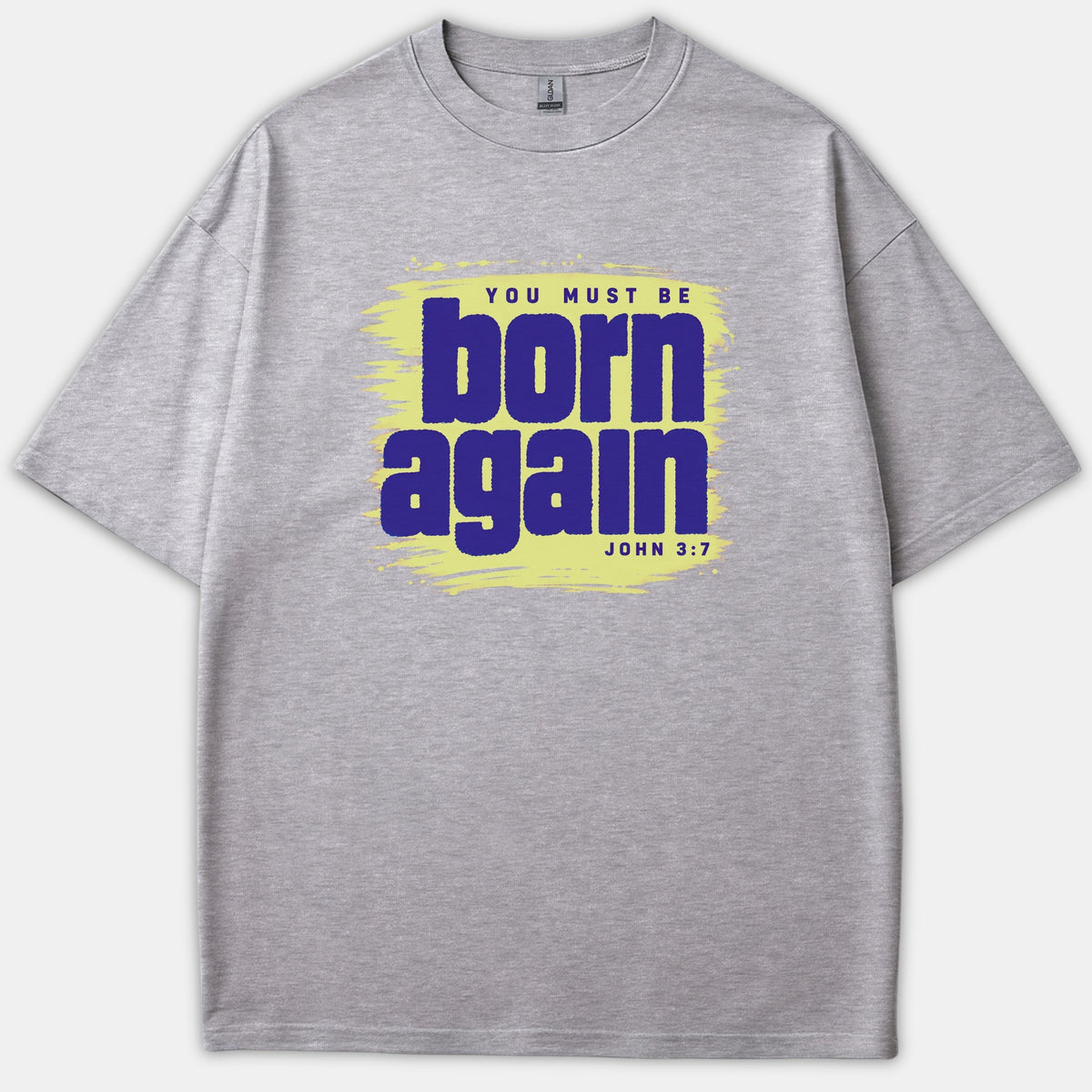 A gray t-shirt featuring a light yellow brushstroke graphic background with purple text reading 'YOU MUST BE born again JOHN 3:7'.