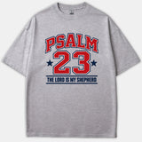 A heather gray t-shirt featuring a athletic varsity-style print that reads PSALM 23 THE LORD IS MY SHEPHERD in bold red and navy blue lettering.
