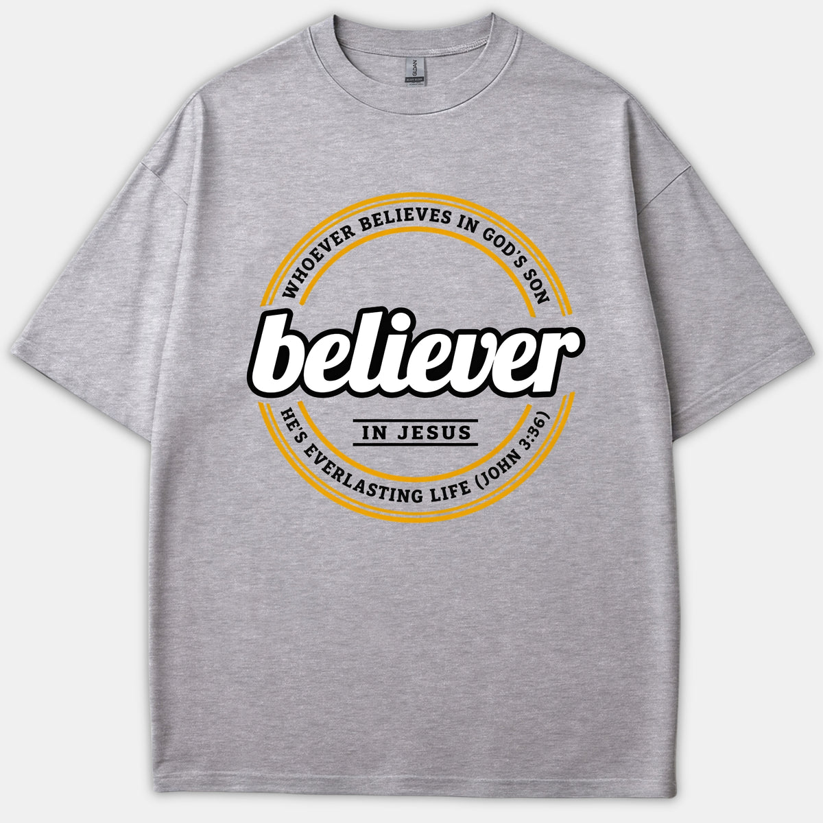 A gray Christian T-shirt featuring a circular black and yellow graphic design with the word 'believer' in bold script and scripture text from John 3:36.