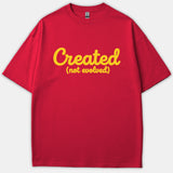 A red Christian t-shirt featuring the text 'Created (not evolved)' printed in a yellow script font across the chest.