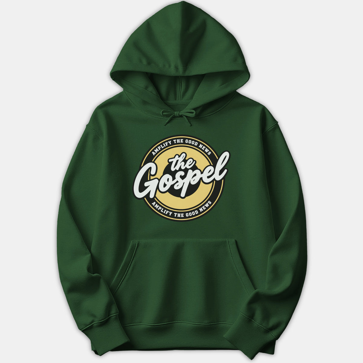 A dark green hoodie featuring a circular graphic print with 'Amplify the Good News' written around white script text reading 'the Gospel'.