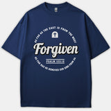 A navy blue t-shirt featuring a circular Christian graphic with the word 'Forgiven' in bold script alongside scripture text from Psalm 103:12.