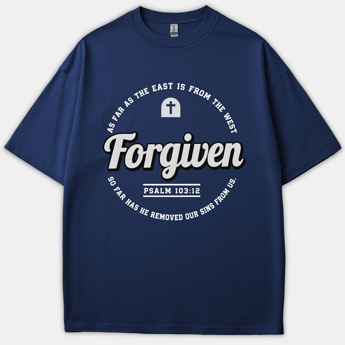A navy blue t-shirt featuring a circular Christian graphic with the word 'Forgiven' in bold script alongside scripture text from Psalm 103:12.