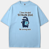 A light blue Christian T-shirt featuring a cute cartoon character wearing sunglasses and holding a Bible, flanked by the text, 'I have decided to follow Jesus, no turning back.'