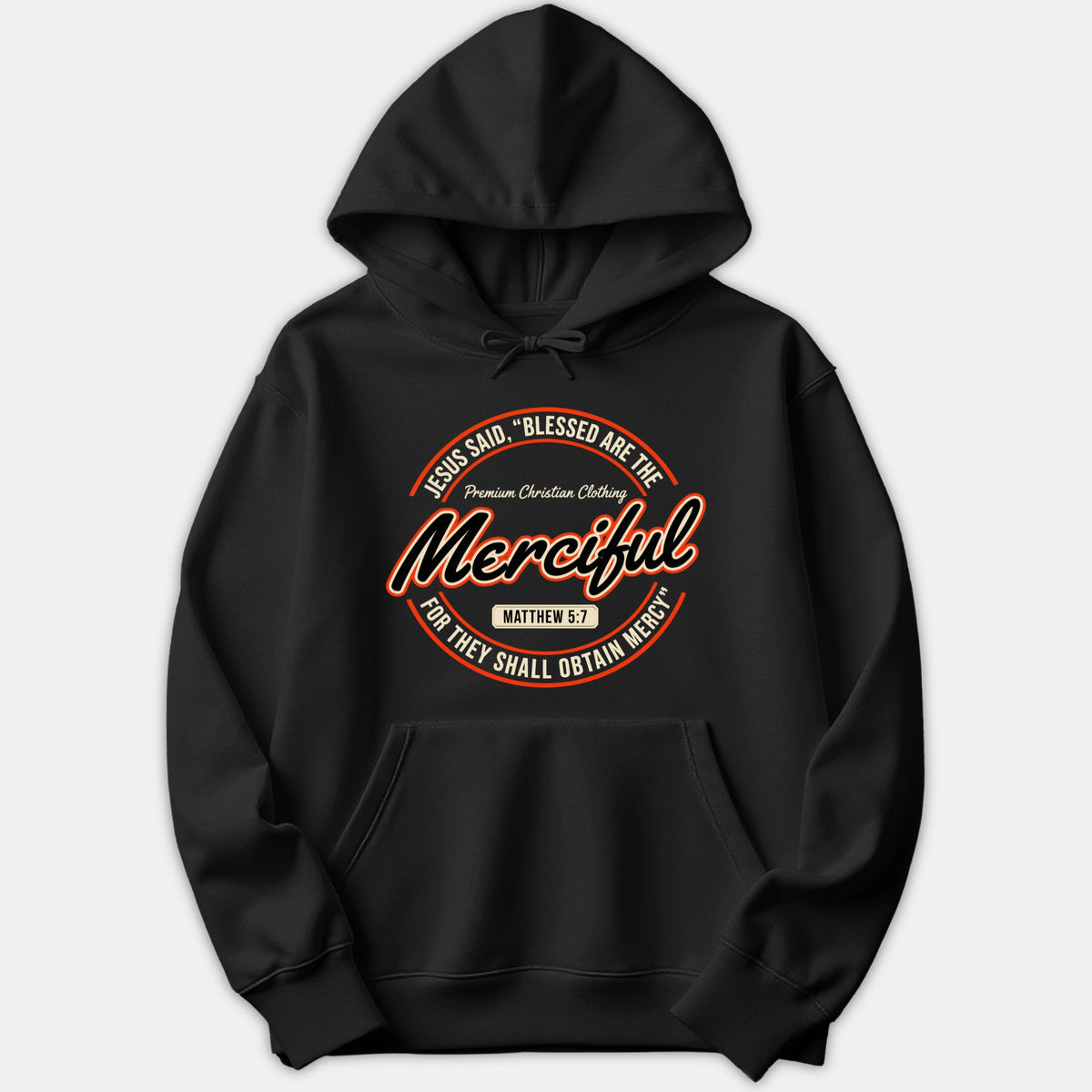 A black pullover hoodie with a circular graphic displaying 'Blessed Are The Merciful' and Matthew 5:7 scripture reference in orange and white typography.