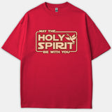 A red T-shirt featuring a Star Wars inspired logo graphic that reads MAY THE HOLY SPIRIT BE WITH YOU accompanied by a flying dove with an olive branch.