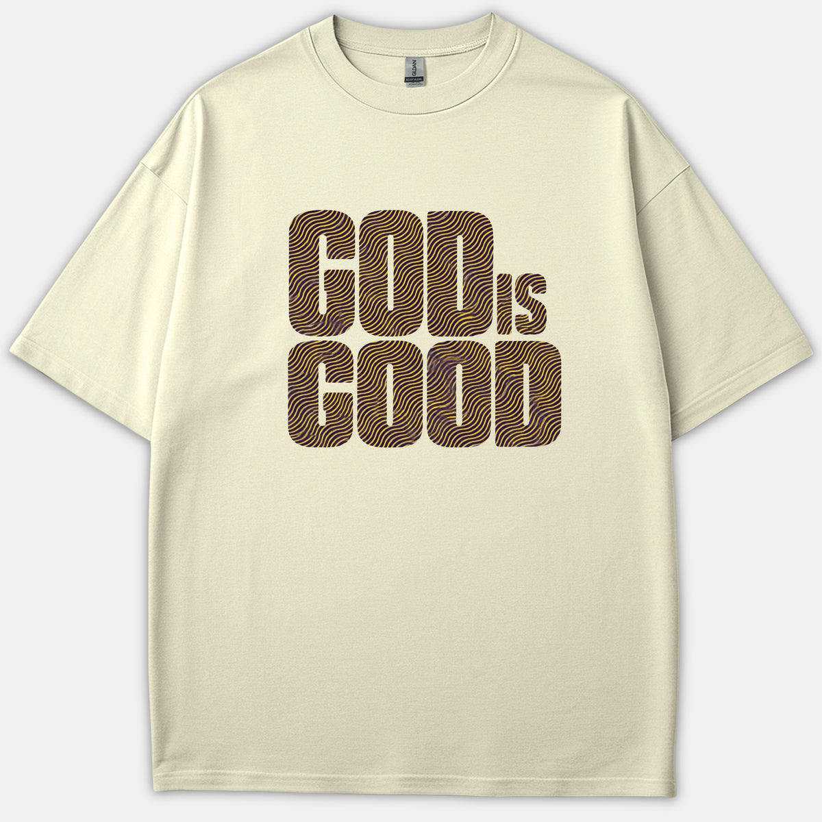 A beige Christian t-shirt featuring a graphic print that reads GOD IS GOOD in bold typography filled with a purple and gold wavy line pattern.