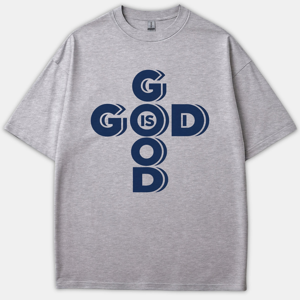 A gray t-shirt featuring a dark navy graphic print reading God Is Good styled in a cross configuration.