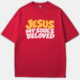 A red t-shirt featuring the phrase 'JESUS MY SOUL'S BELOVED' printed on the chest in bold yellow and white typography.