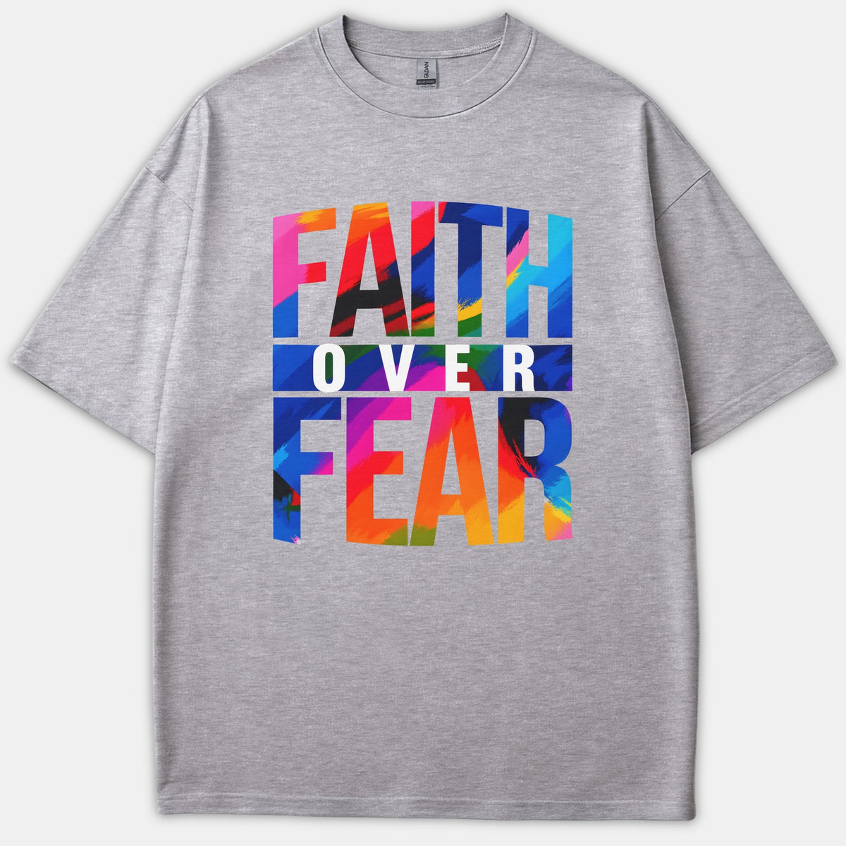 A gray t-shirt featuring a vibrant colorful brushstroke graphic that reads FAITH OVER FEAR printed across the front.