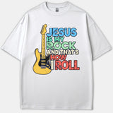 A white graphic t-shirt featuring a vintage yellow electric guitar alongside colorful vintage typography that reads Jesus Is My Rock And That's How I Roll.