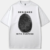 A white graphic t-shirt featuring a large black fingerprint illustration with the phrase DESIGNED WITH PURPOSE printed in bold letters.