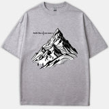 A gray t-shirt featuring a detailed black and white mountain graphic with text reading faith like a mustard seed can move mountains.
