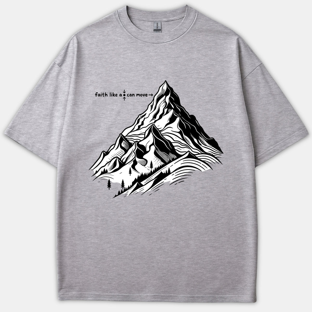 A gray t-shirt featuring a detailed black and white mountain graphic with text reading faith like a mustard seed can move mountains.