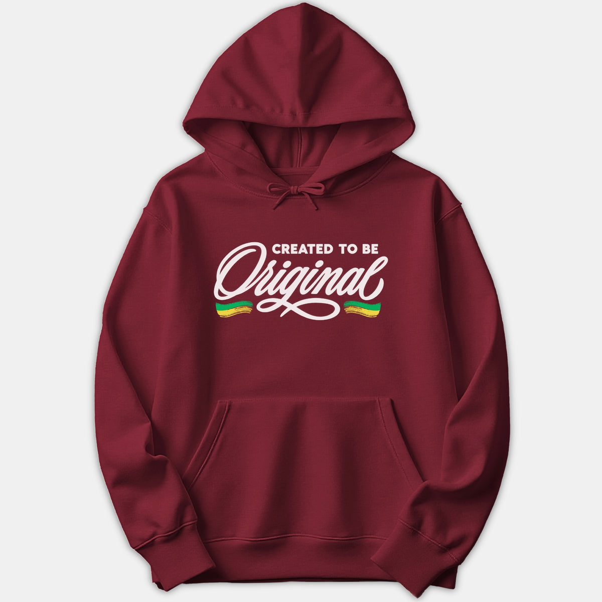 A maroon red hoodie featuring the graphic text CREATED TO BE Original in bold white lettering with green and yellow accents on the chest.