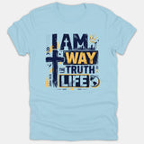 A light blue T-shirt featuring a Christian graphic design that reads 'I Am The Way The Truth The Life' with a cross graphic and yellow accents.