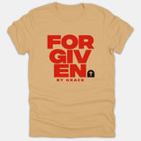 A beige Christian T-shirt featuring the phrase FORGIVEN BY GRACE in bold red block lettering alongside an empty tomb graphic with a cross.