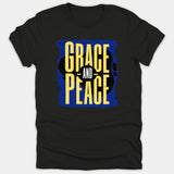 A black T-shirt featuring a graphic design with the words 'Grace and Peace' in bold yellow text over a distressed blue background.